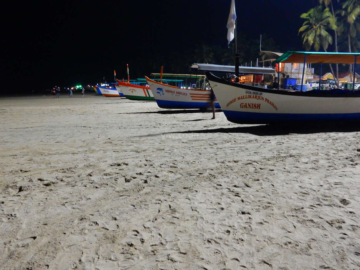 Boats queued at palolem beach in night
